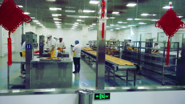 文化产业园内维吾尔人正在制作饢饼